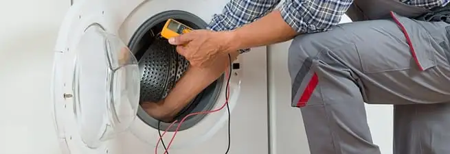 Dryer repair technician inspecting and repairing a clothes dryer in Clearwater, FL