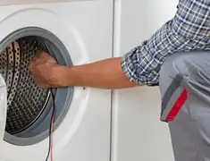Dryer repair technician diagnosing and servicing a clothes dryer in Clearwater, FL