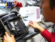 Vacuum repair technician servicing internal components on a workbench in Clearwater, FL