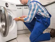 Washing machine repair technician servicing a front-load washer in Clearwater, FL