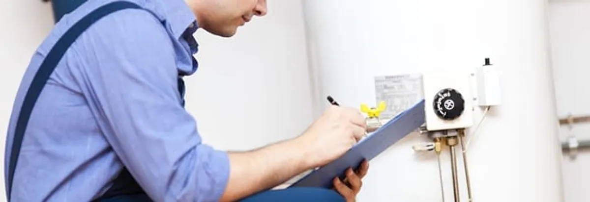 Water heater repair technician inspecting the unit and recording service notes in Clearwater, FL